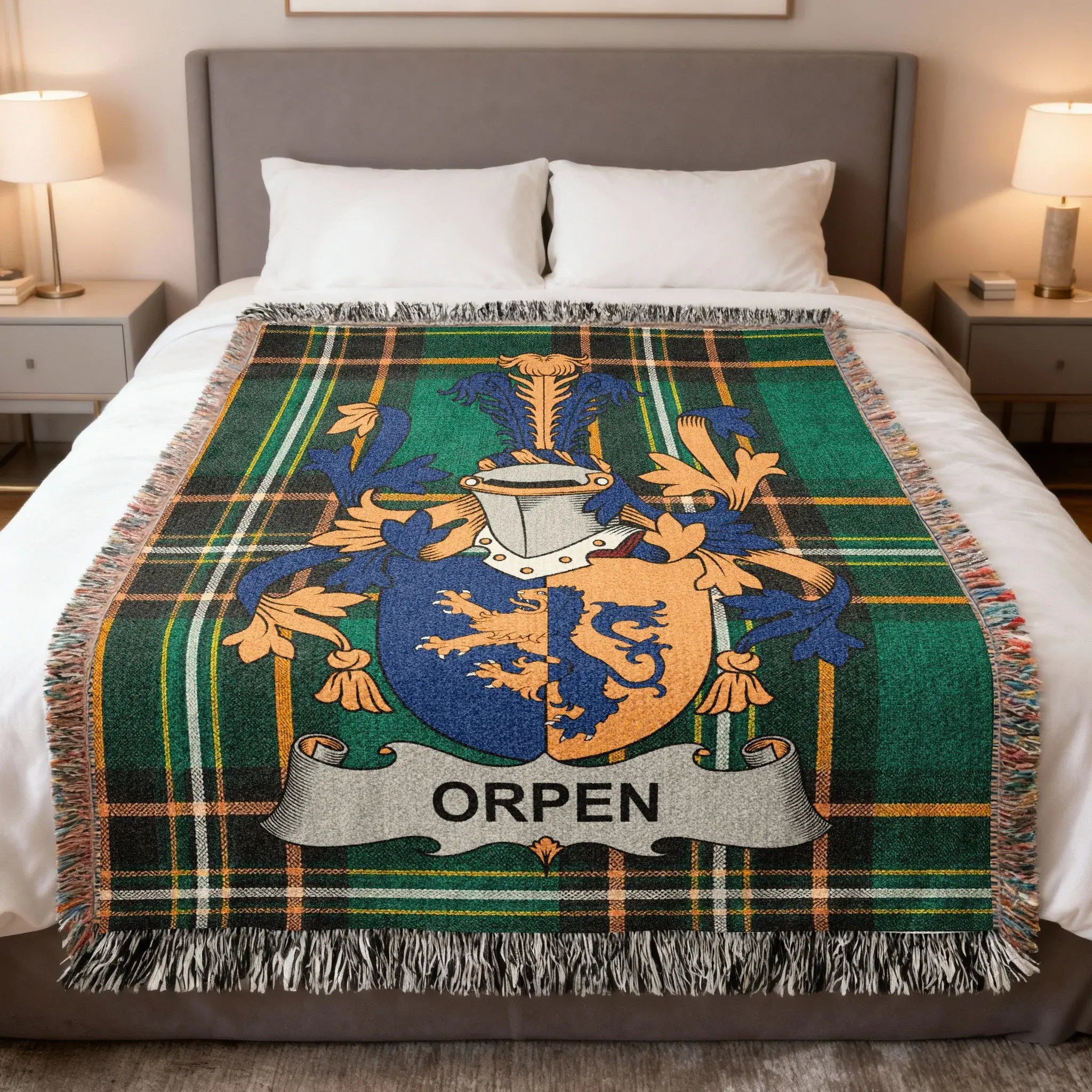 Plaid throw blanket with Orpen family crest on a bed.