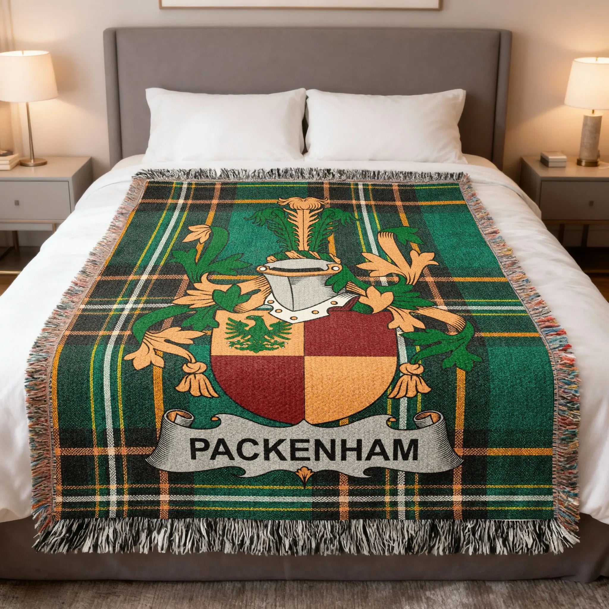 Green plaid throw blanket with Packenham family crest on a bed.
