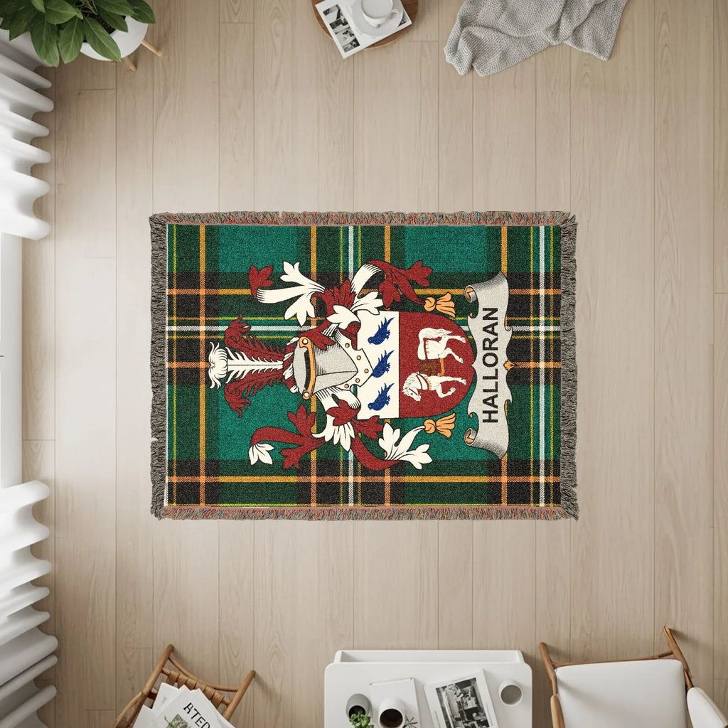 Halloran clan crest on a tartan plaid woven throw blanket.