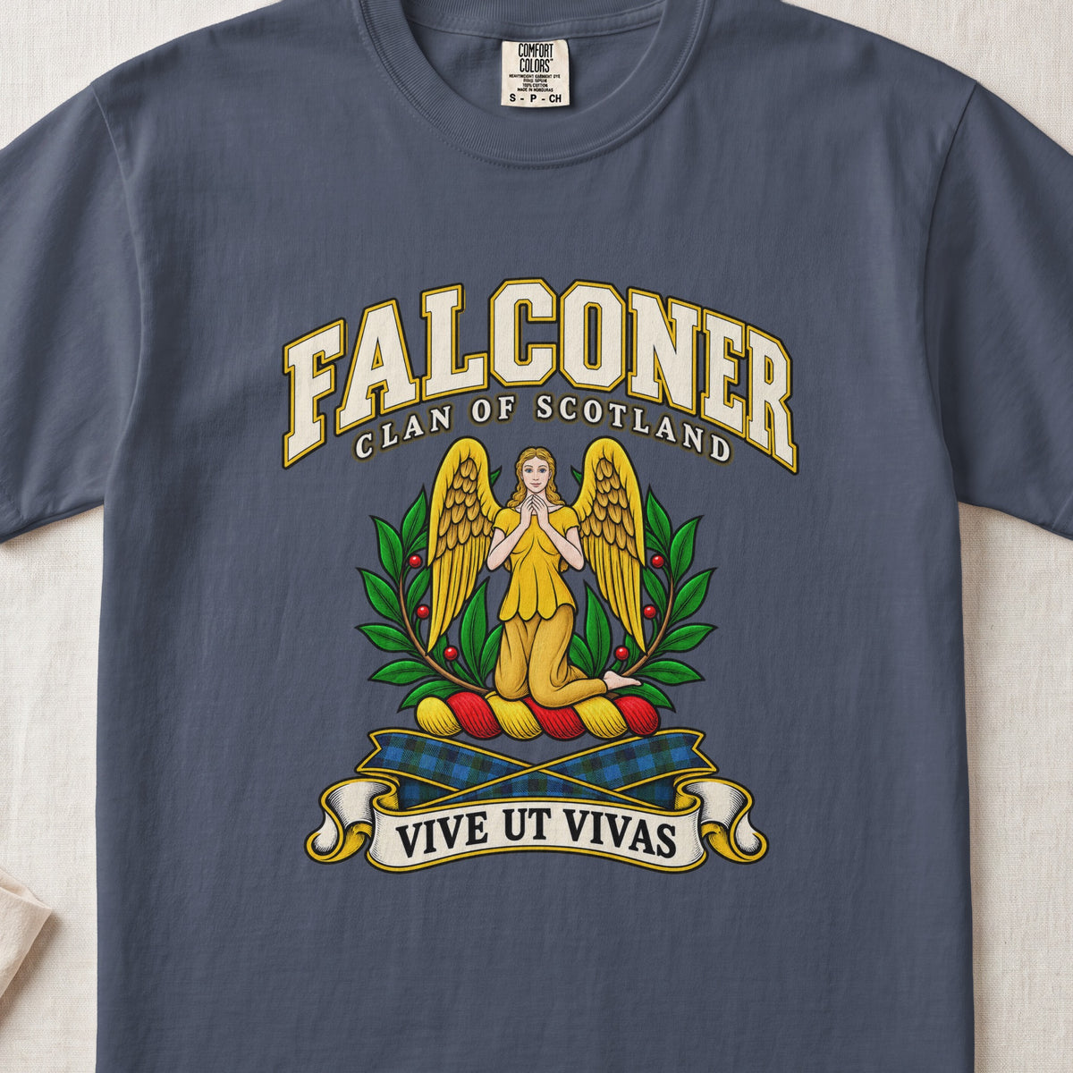 Falconer Scottish clan T-shirt in Midnight, front view with a kneeling gold-winged figure surrounded by green branches and motto banner.