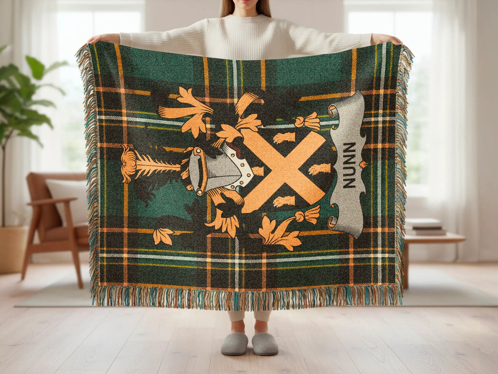 Green tartan blanket with Nunns family crest featuring a large orange X.