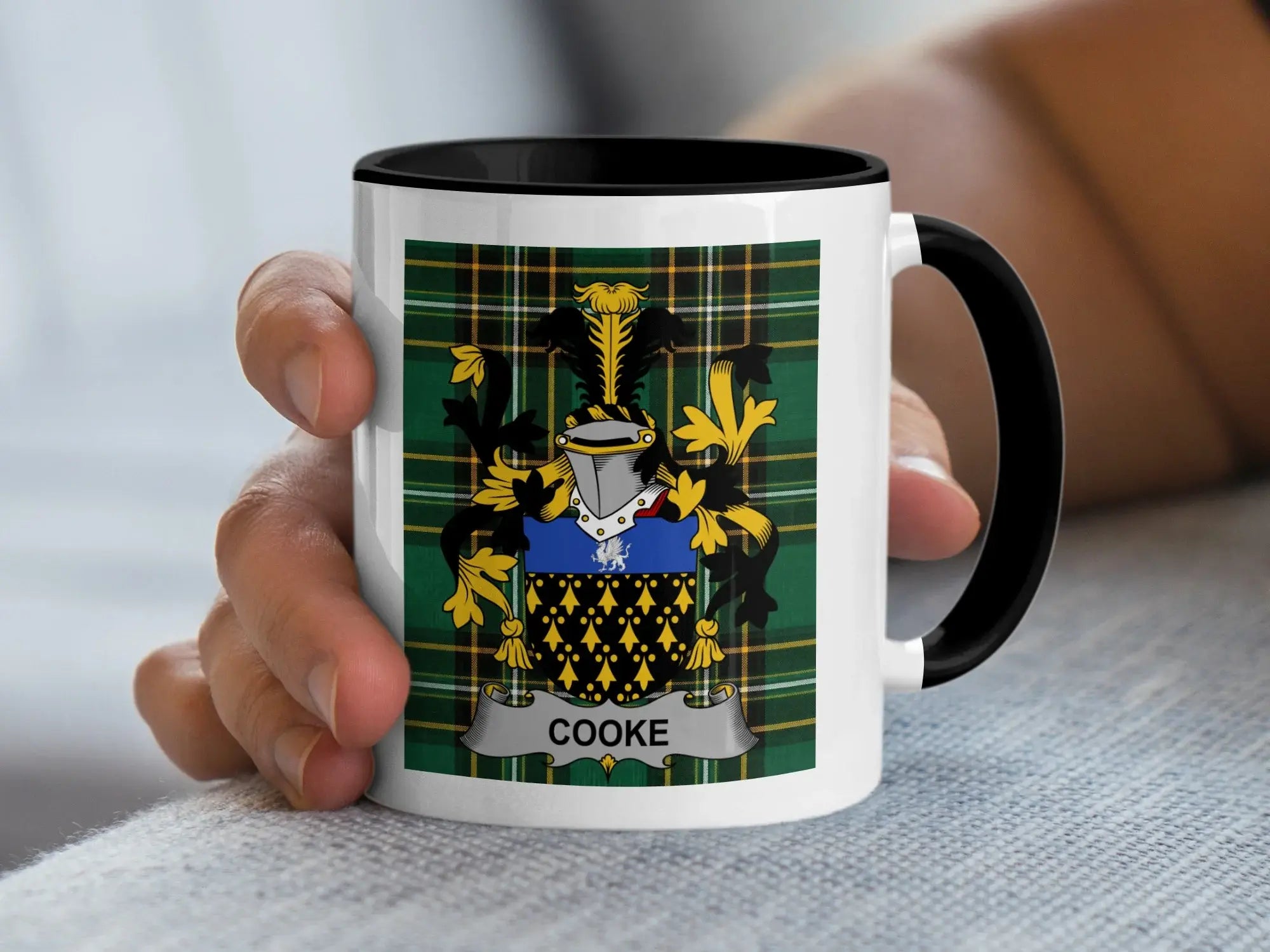 White mug with black handle featuring a family crest with the name COOKЕ.
