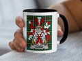 White mug with black rim featuring Harne family crest on green tartan background.