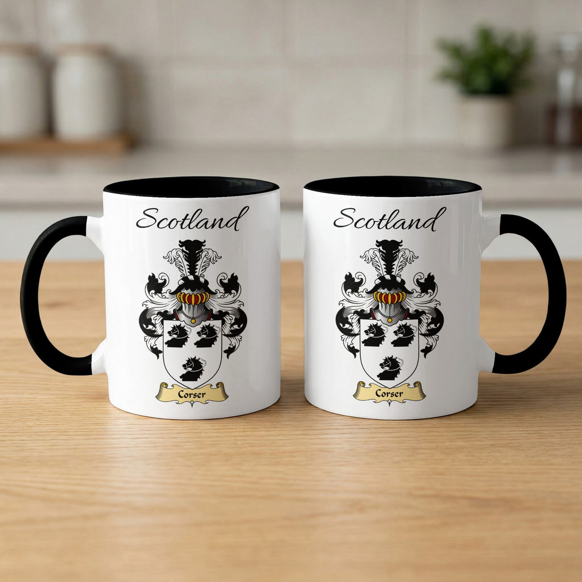 Pair of black-accent Corser mugs showing the double-sided Scottish family shield design on white ceramic.