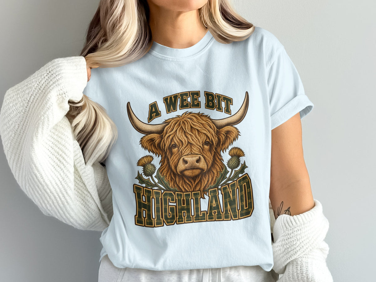 Model wearing the A Wee Bit Highland Highland cow Comfort Colors T-shirt in Chambray