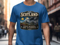 Blue t-shirt with "Scotland: Four Seasons, One Afternoon" graphic and landscape.