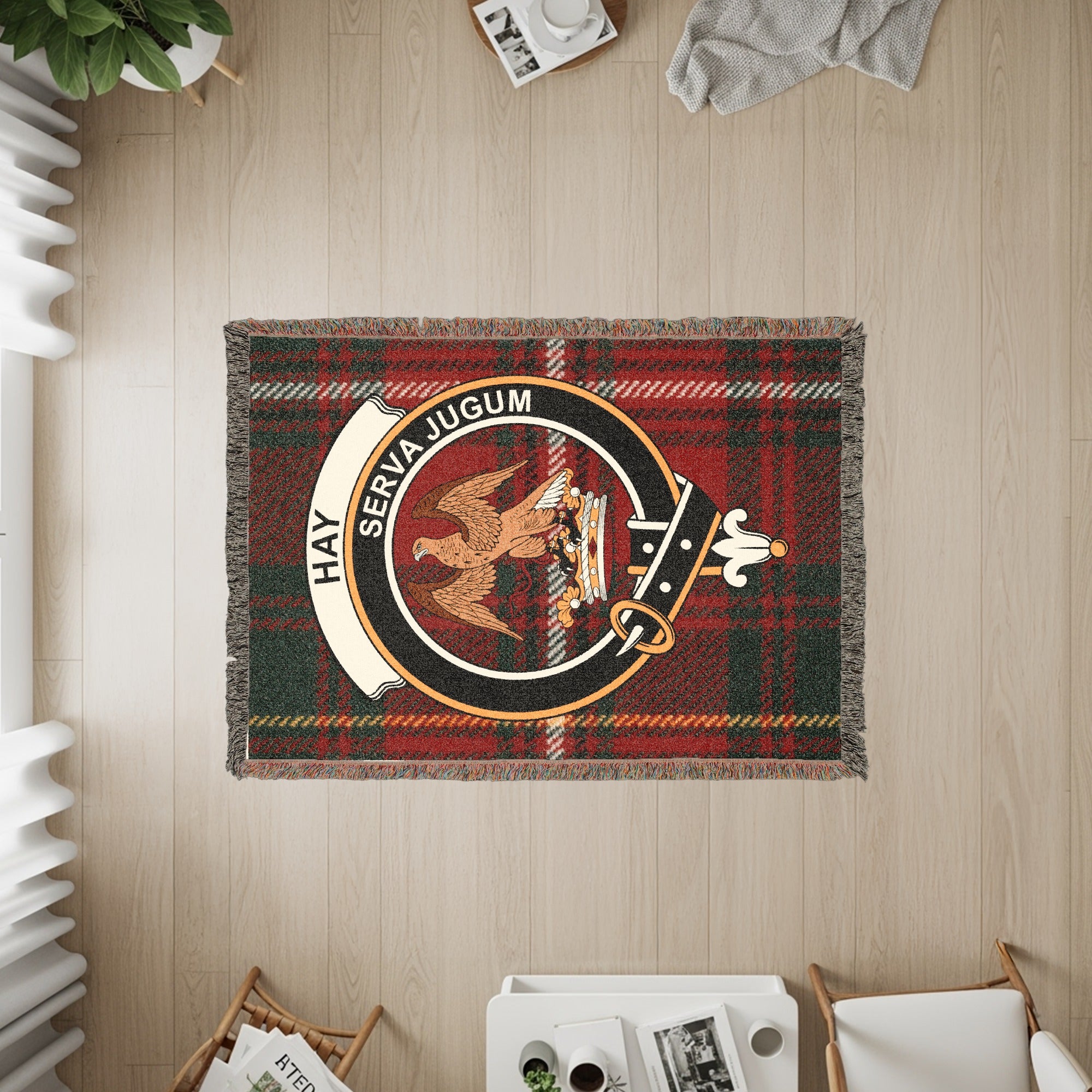 Tapestry with plaid pattern and Hay Serva Jugum clan crest featuring a bird and crown.
