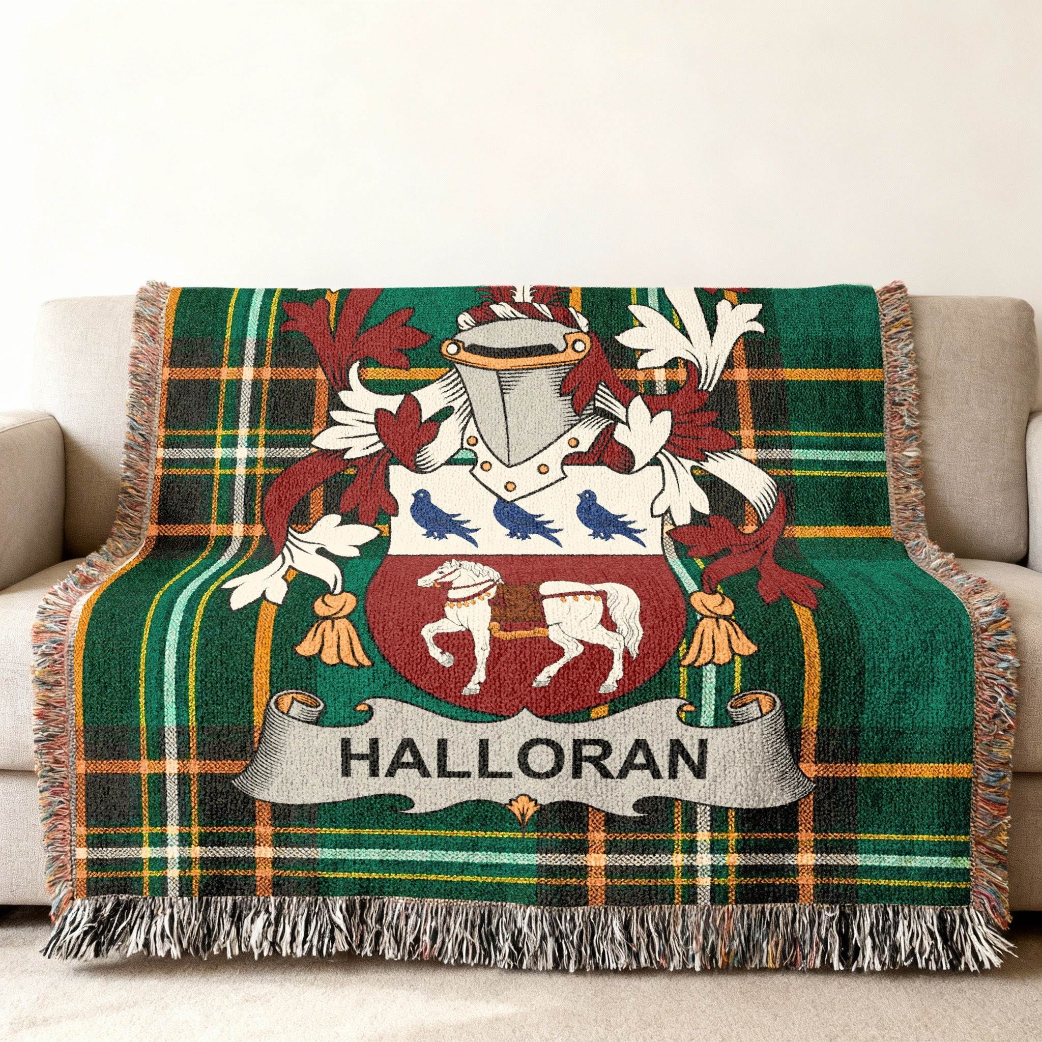 Green tartan throw blanket with HALLORAN family crest featuring horses and birds.
