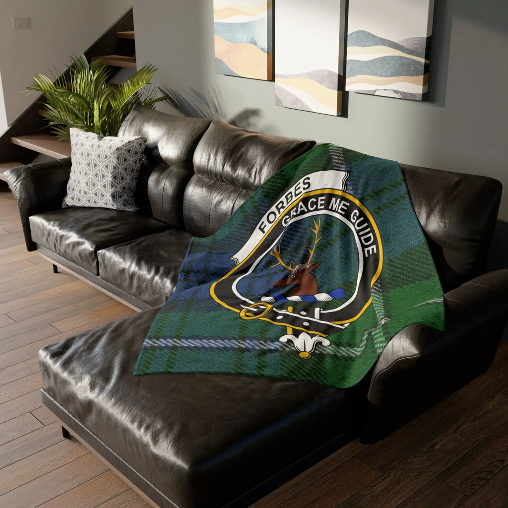 Forbes clan tartan throw blanket on sofa — 50x60 polyester, stag crest and Grace Me Guide motto
