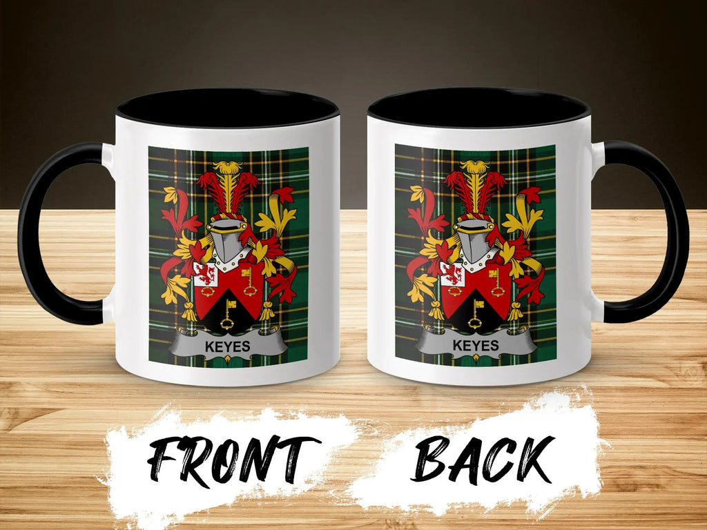 Mug with Keyes crest on front and back, black handle, on a wooden surface.