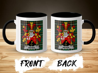 Mug with Keyes crest on front and back, black handle, on a wooden surface.