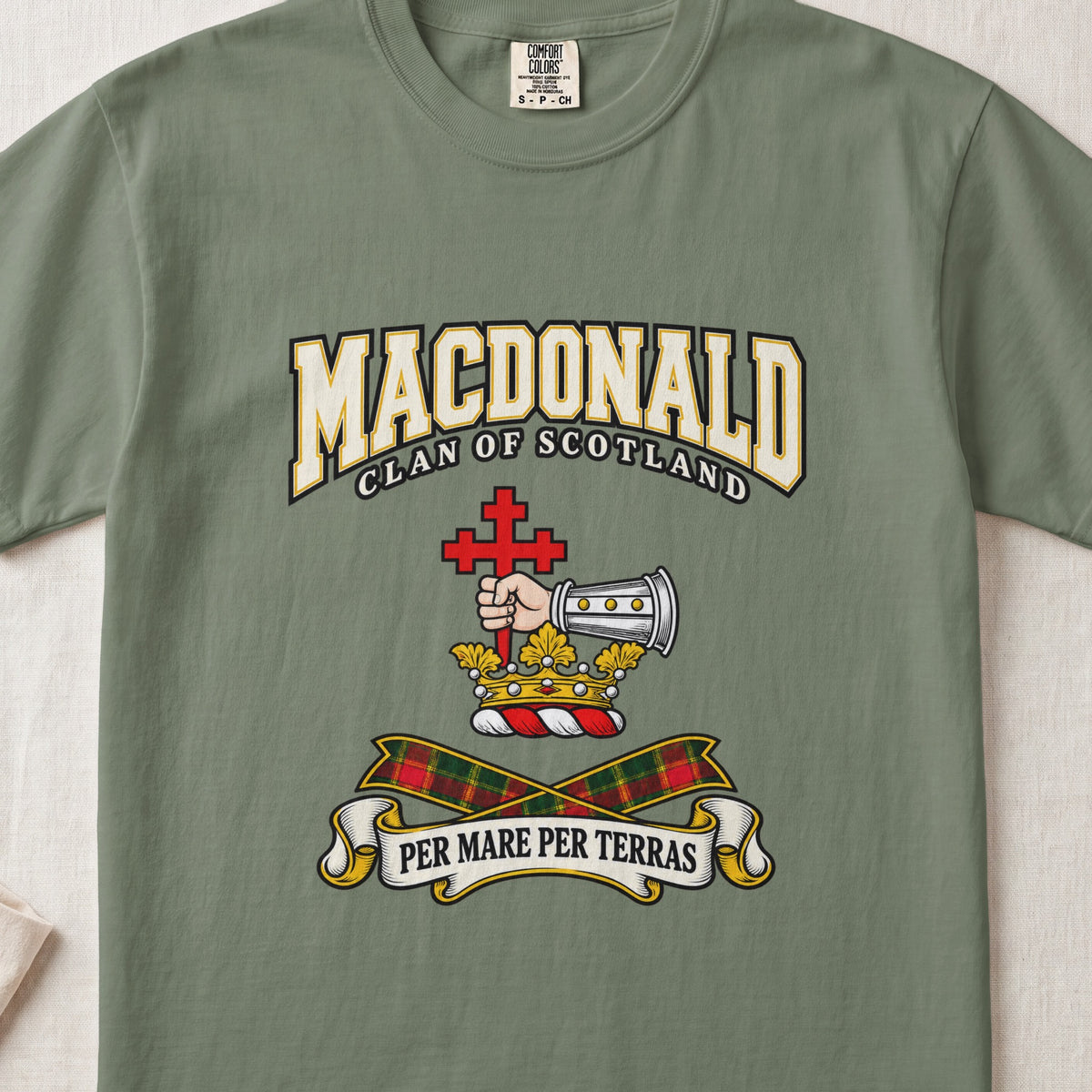 MacDonald graphic T-shirt in Moss green, front flat lay showing varsity lettering and armoured forearm with hand holding red cross.