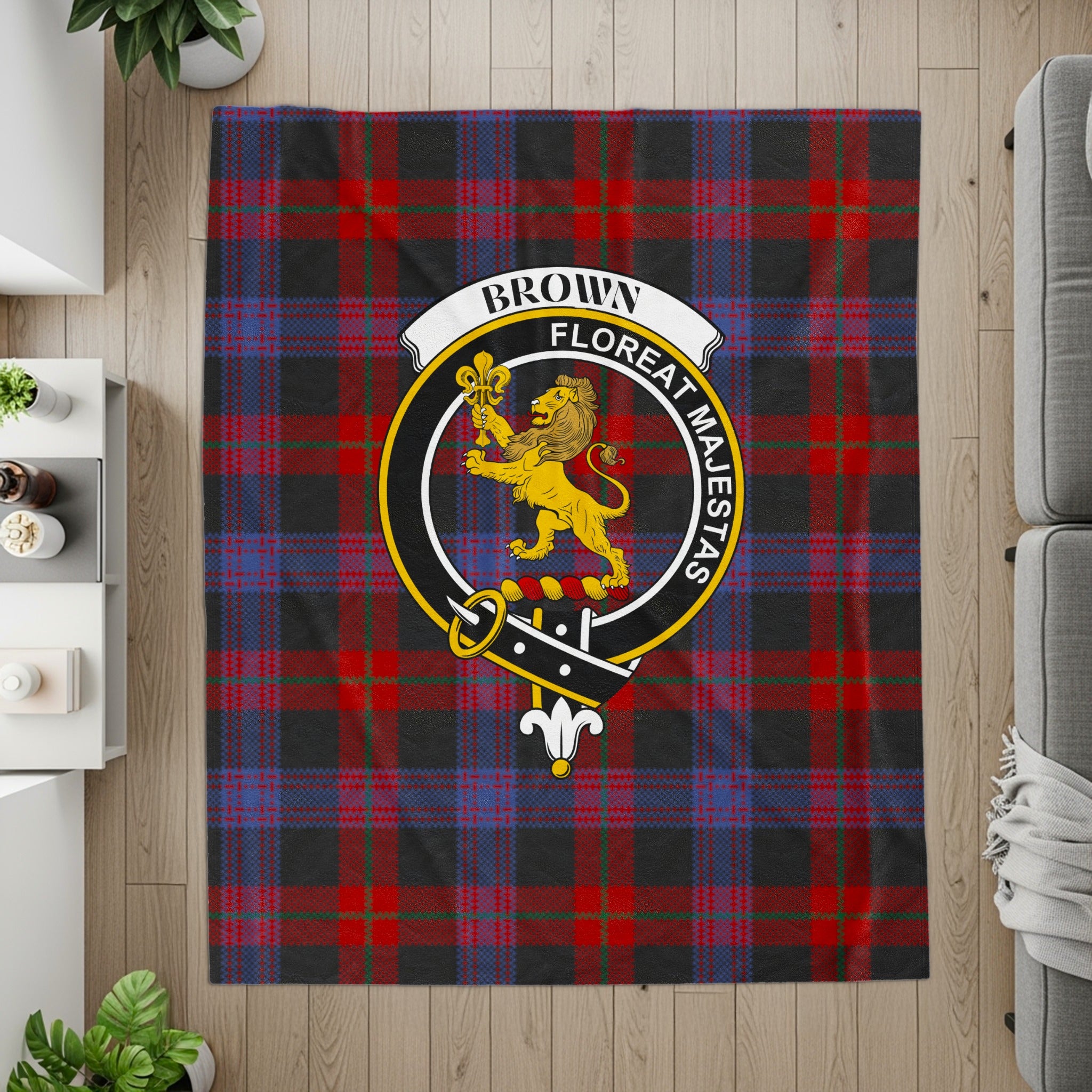 Brown crest and motto on tartan printed throw — flat lay detail