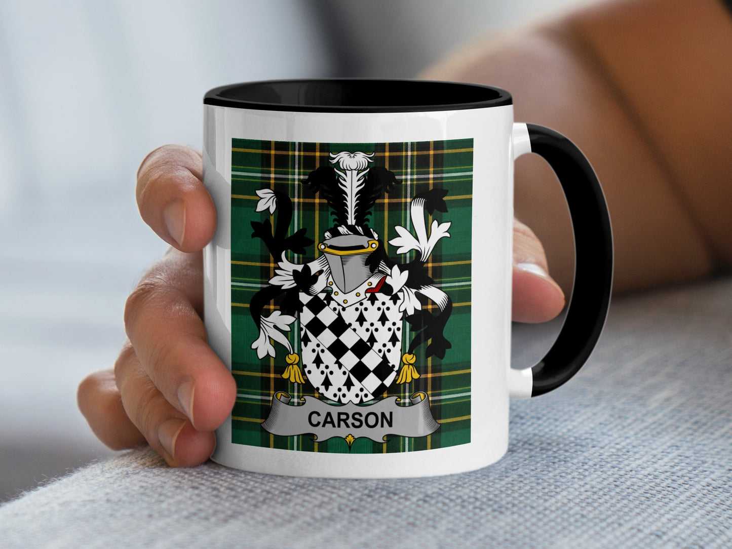 White mug with black rim featuring a green plaid pattern and the surname CARSON in a crest.
