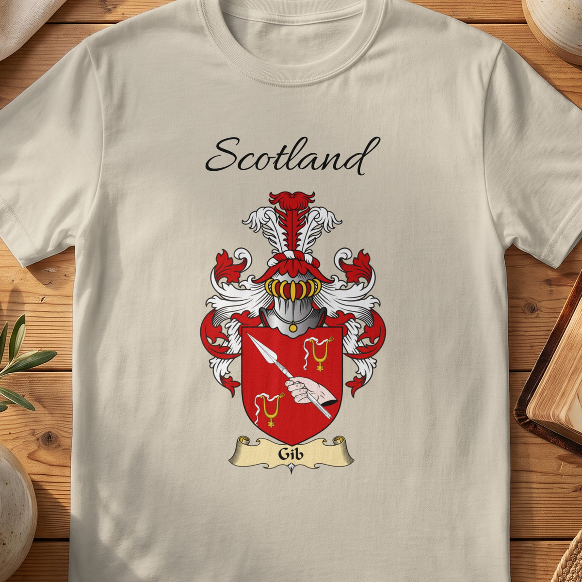 Sand Gib Scottish family shield T-shirt featuring a hand holding a diagonal spear on red
