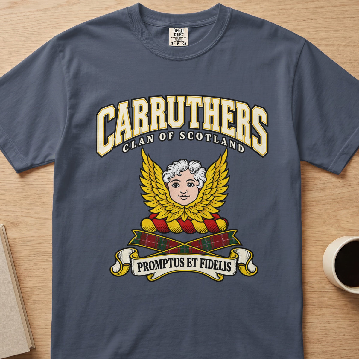 Carruthers pale face framed by golden wings graphic on a slate blue Comfort Colors T-shirt, front view