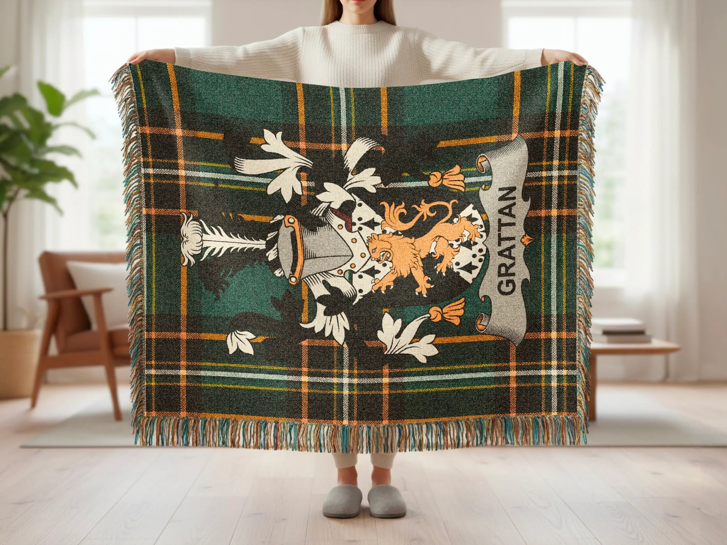 Green tartan blanket with a coat of arms and the name GRATTAN.