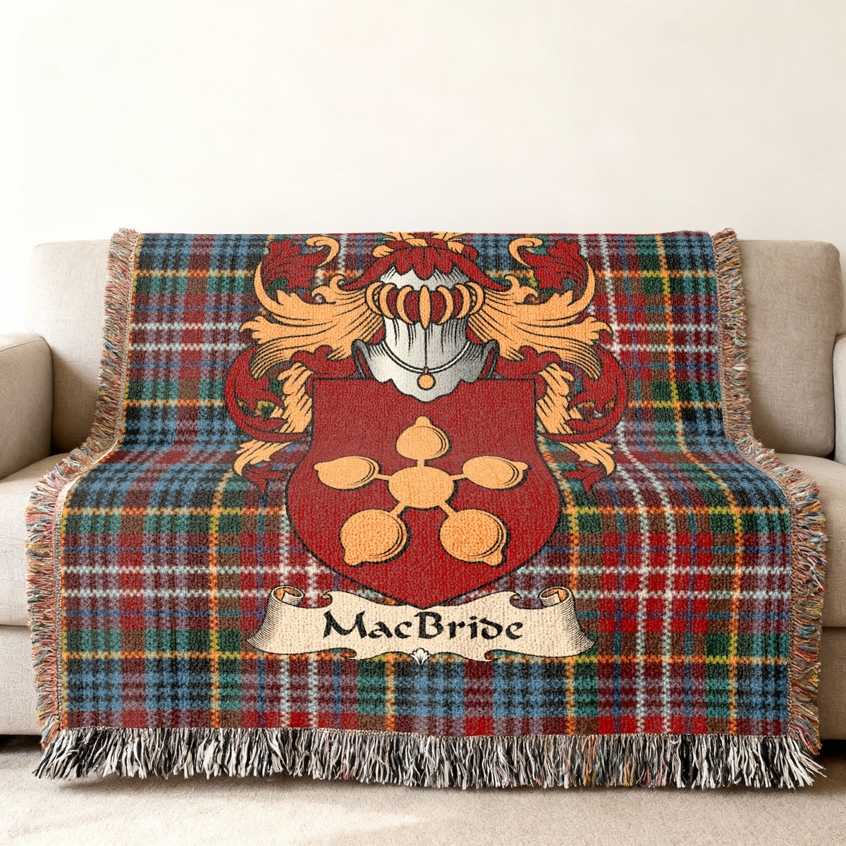 MacBride family crest emblem on a Caledonia tartan woven blanket