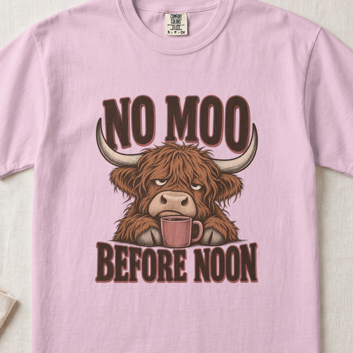No Moo Before Noon Highland cow design on a Blossom Comfort Colors 1717 T-shirt, flat lay