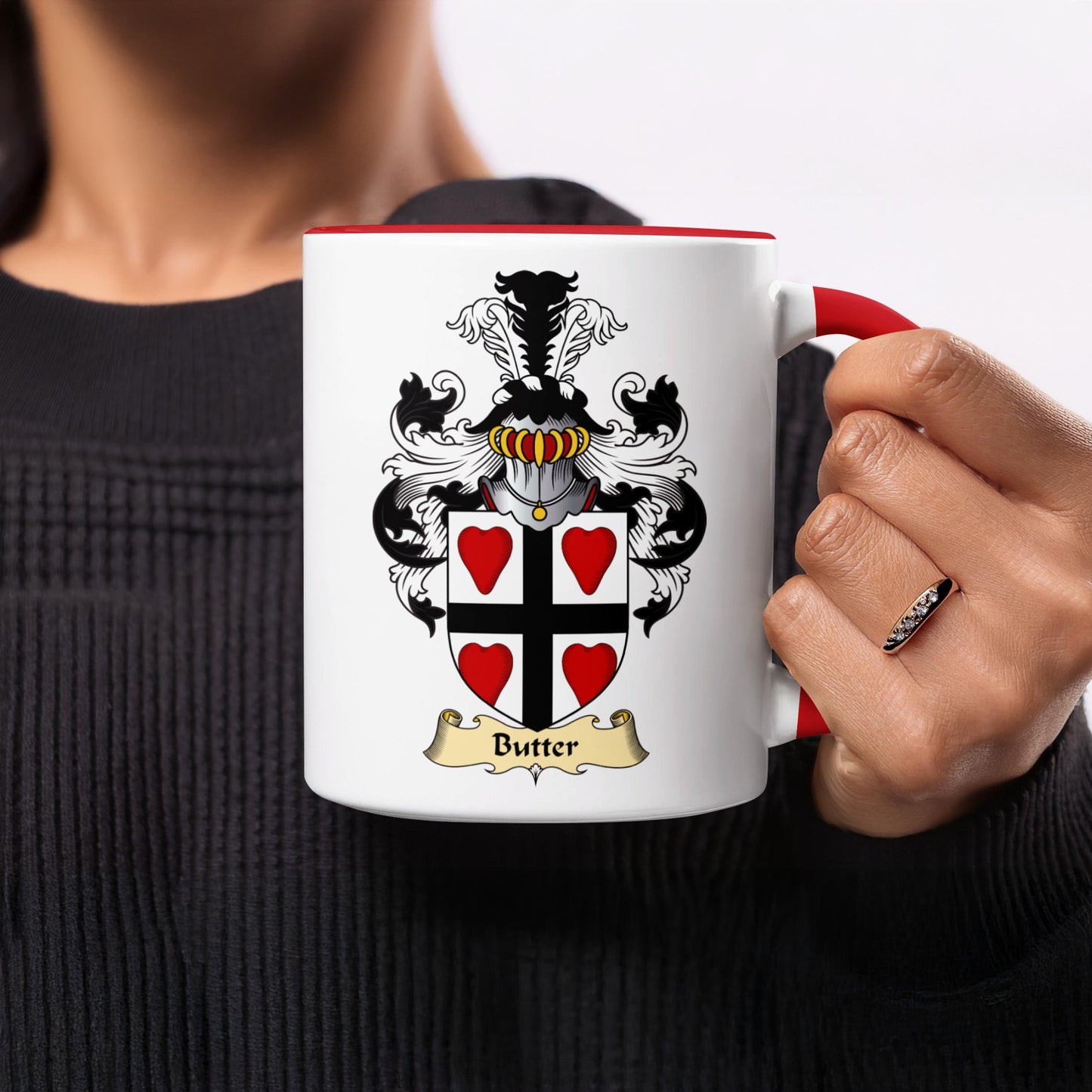 White mug with red handle, featuring the Butter family crest and a gold banner.