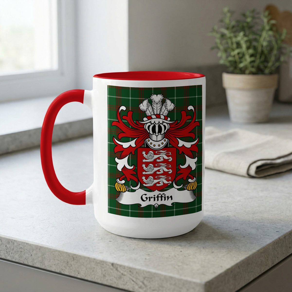 White mug with red handle and interior, featuring Griffin crest on green plaid design.