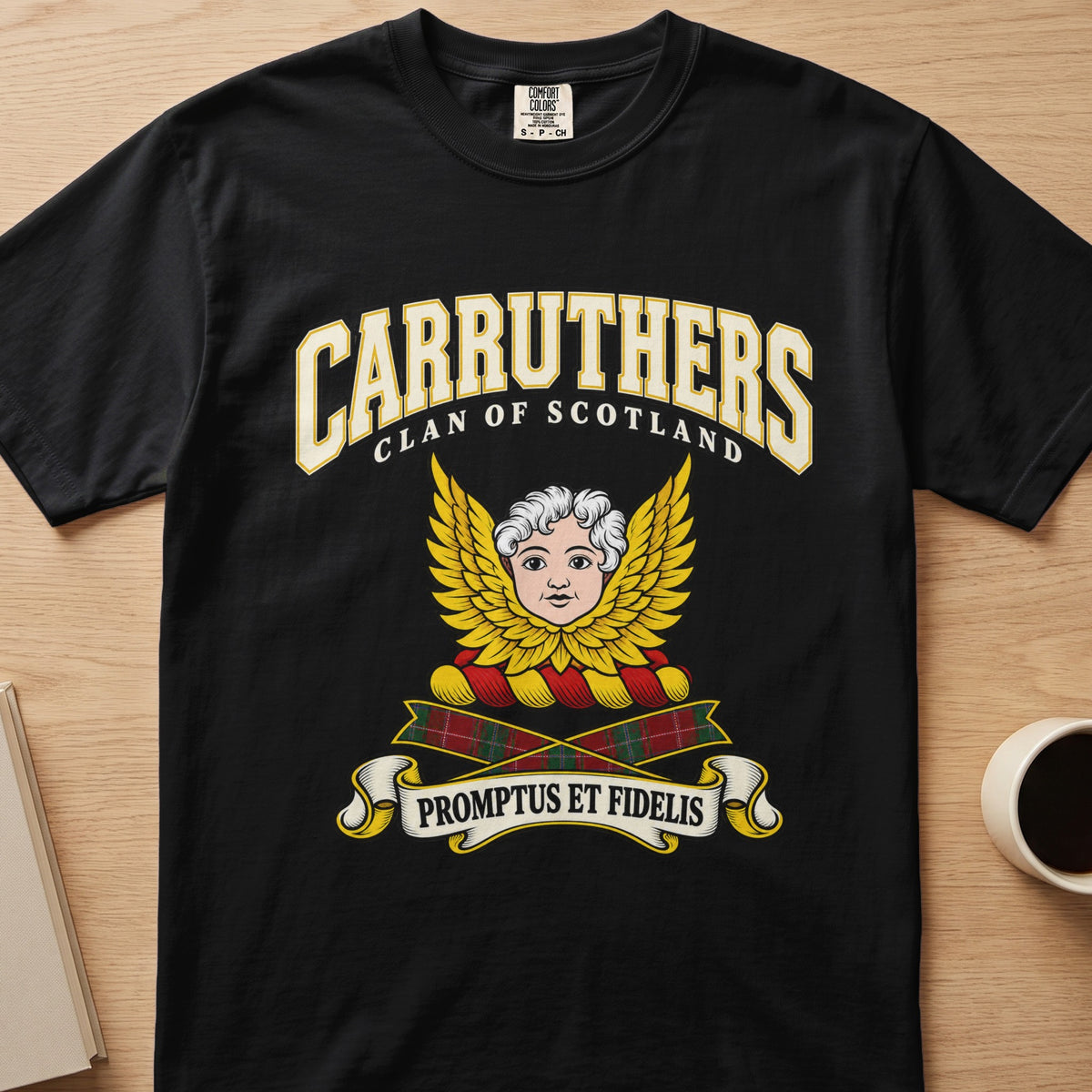 Carruthers pale face framed by golden wings graphic on a black Comfort Colors T-shirt, front view