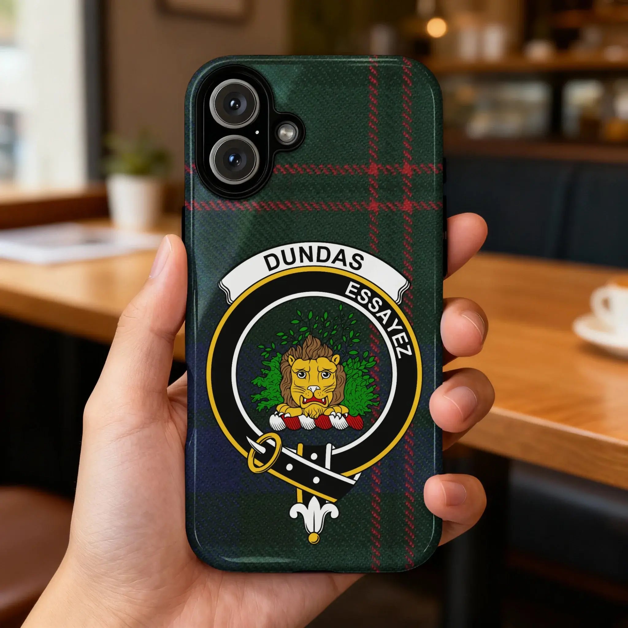 Clan Dundas tartan case on phone — slim glossy finish, lion crest detail visible, angled view