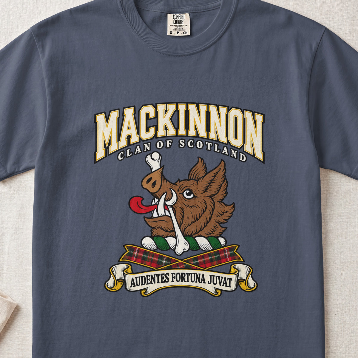 MacKinnon graphic T-shirt in Midnight blue, front flat lay showing varsity lettering and brown boar head with white tusks, red tongue and a white bone.
