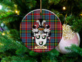Forrester Scottish clan ceramic ornament with family crest on a Caledonia tartan background, hanging on a Christmas tree