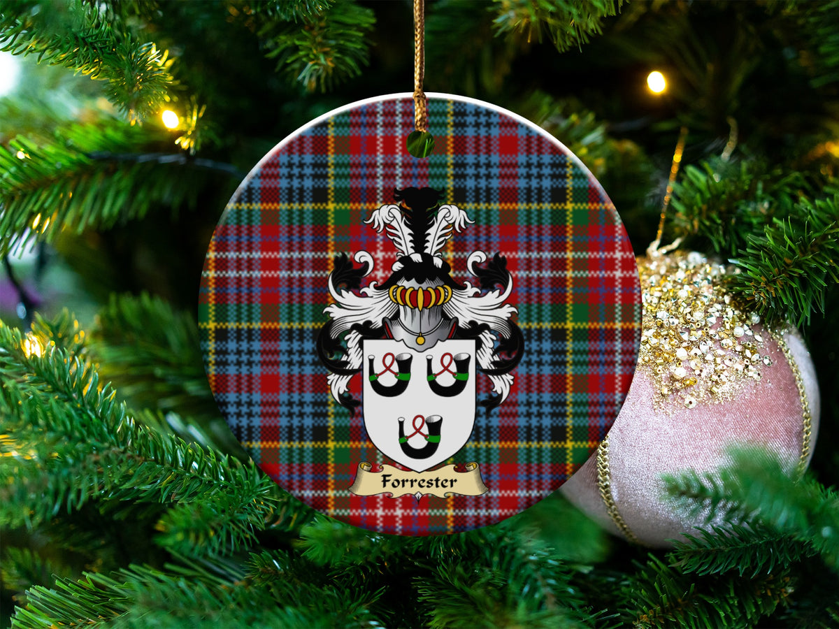 Forrester Scottish clan ceramic ornament with family crest on a Caledonia tartan background, hanging on a Christmas tree