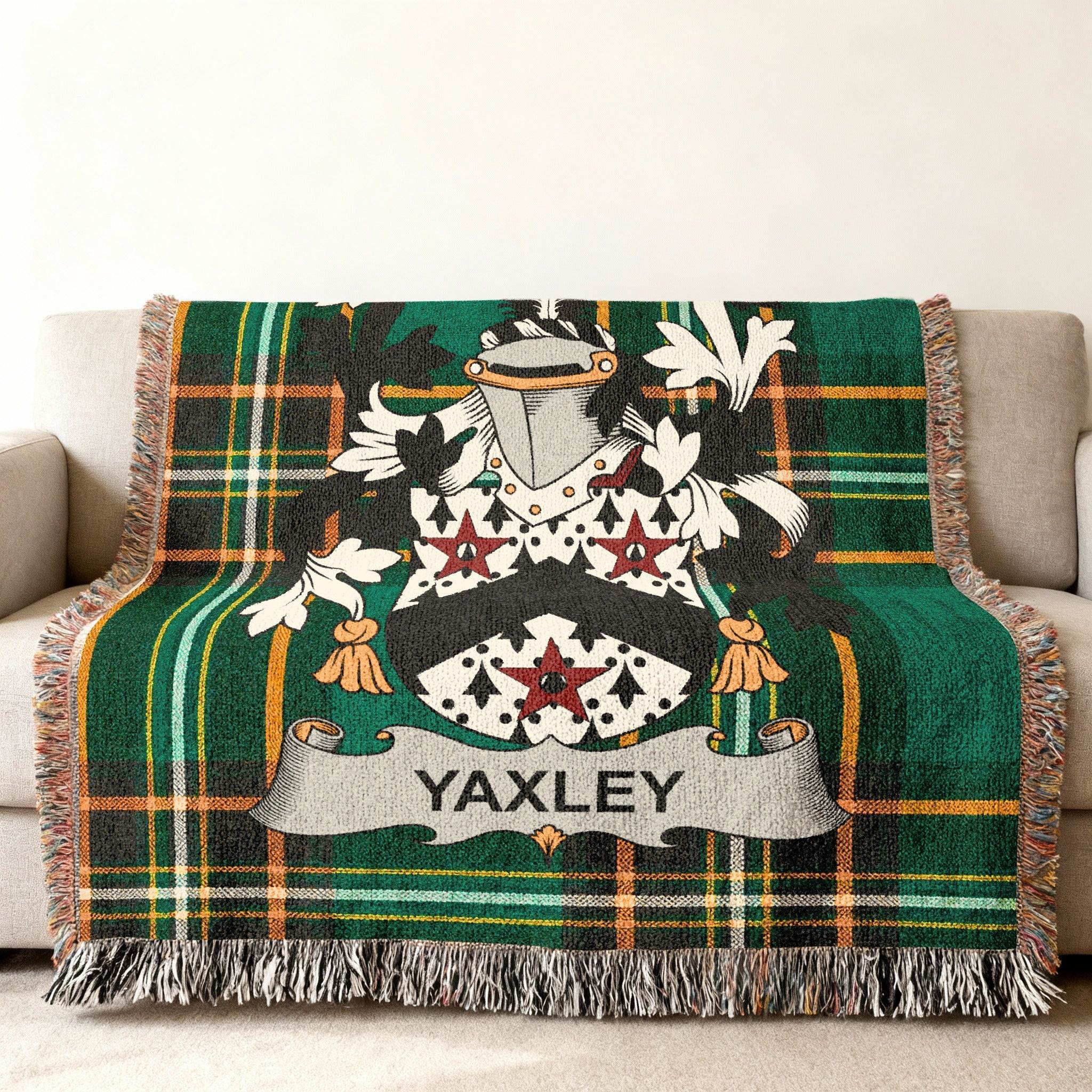 Tartan throw blanket with Yaxley family crest on a sofa.