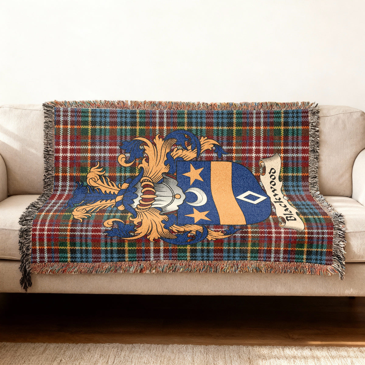 Blackwood family crest emblem on a Caledonia tartan woven blanket