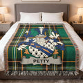 Green and blue tartan throw blanket with Petty family crest centered.