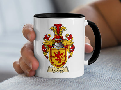 White mug with black rim and handle, featuring a Scotland family crest.