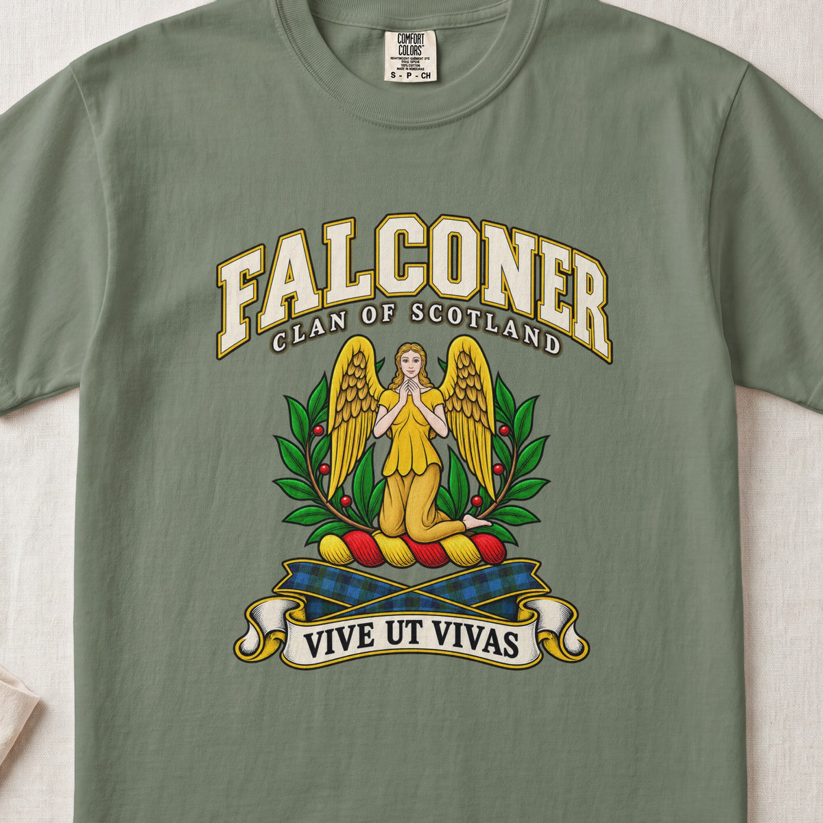 Falconer Scottish clan T-shirt in Moss, front view with a kneeling gold-winged figure surrounded by green branches and motto banner.