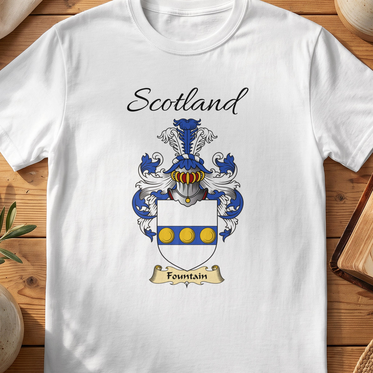 White Fountain Scottish family shield T-shirt featuring three gold circles along a blue band
