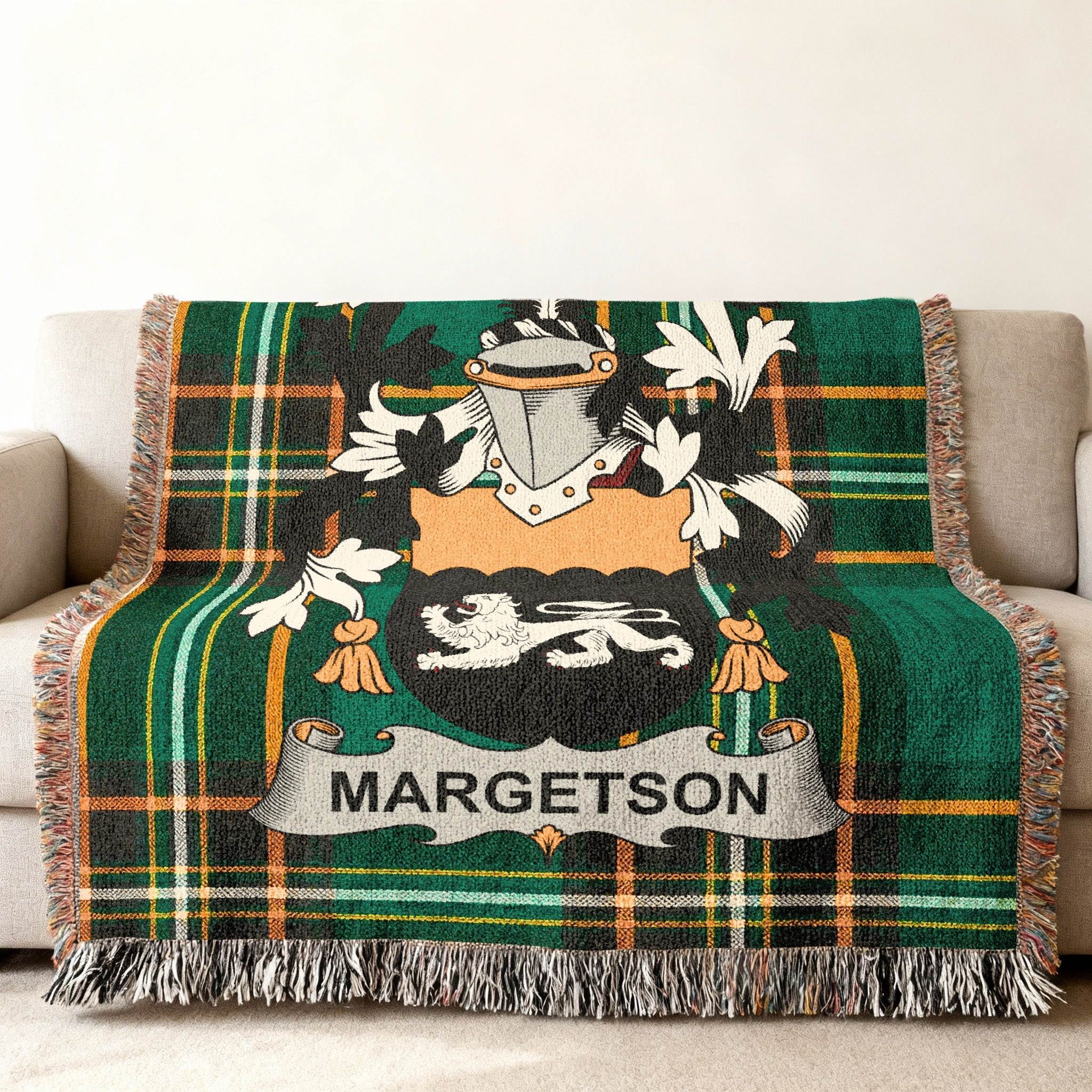Green tartan blanket with MARGETSON family crest draped on a sofa.