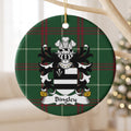 Bingley ornament hanging from a pale wooden branch; two black bars on white with a white arrowhead in a black corner panel on Welsh national tartan.