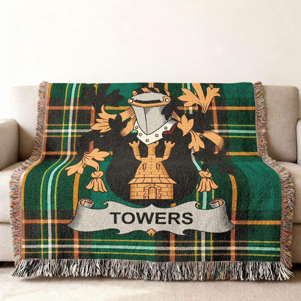 Towers family crest on a green plaid woven blanket with fringe.