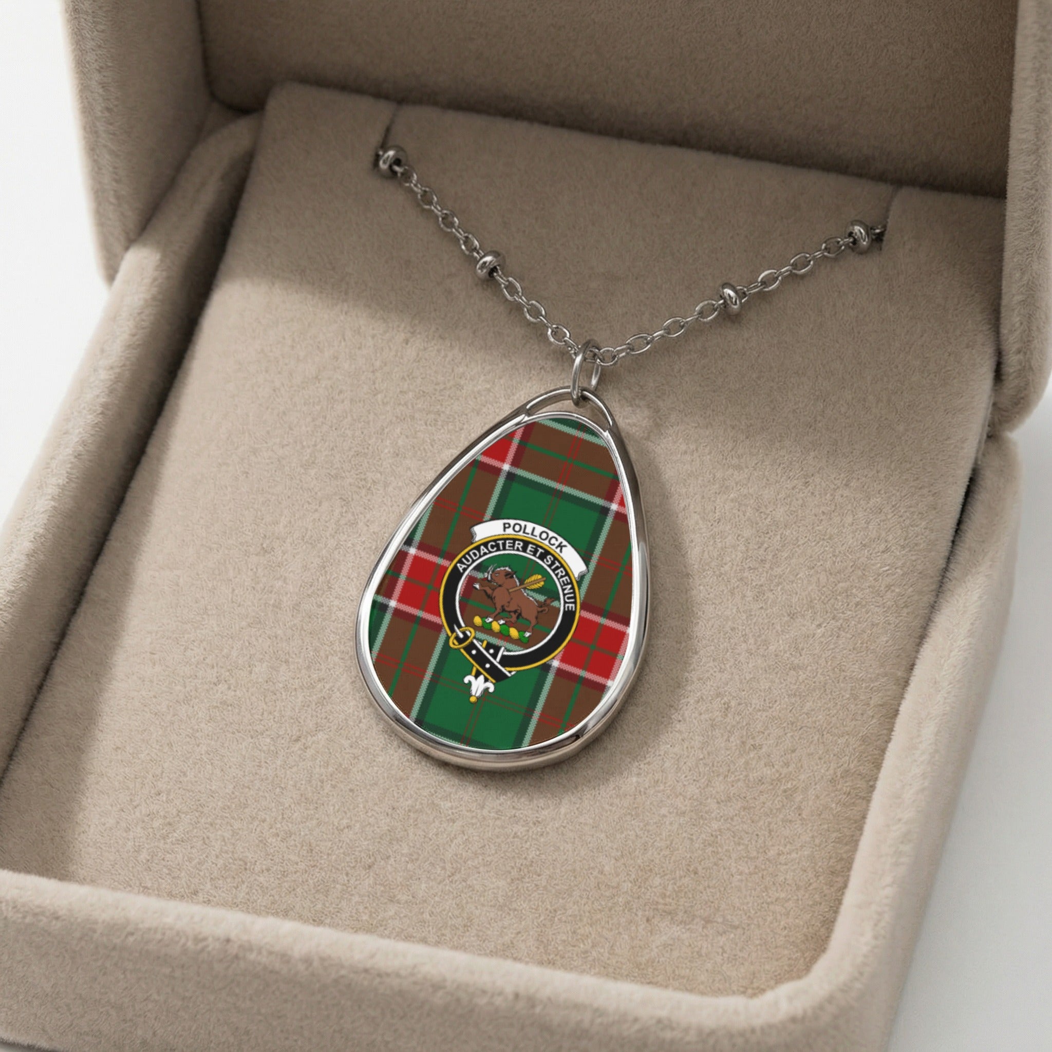Pendant necklace with Pollock tartan and crest, displayed in a beige jewelry box.