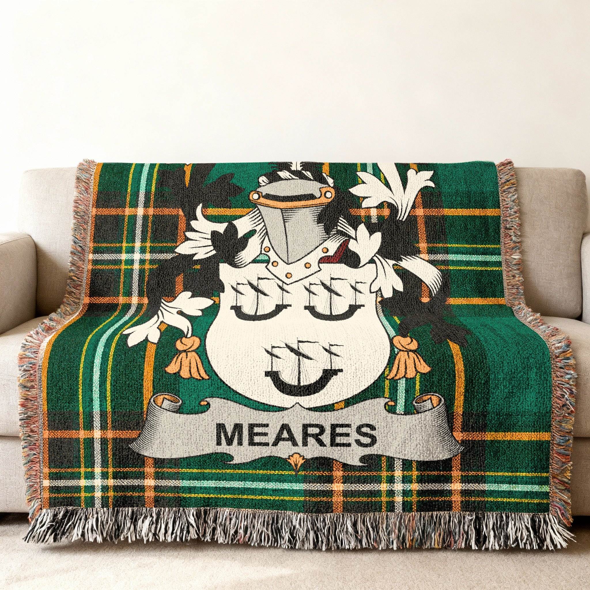 Green plaid blanket with the Meares family crest in the center.