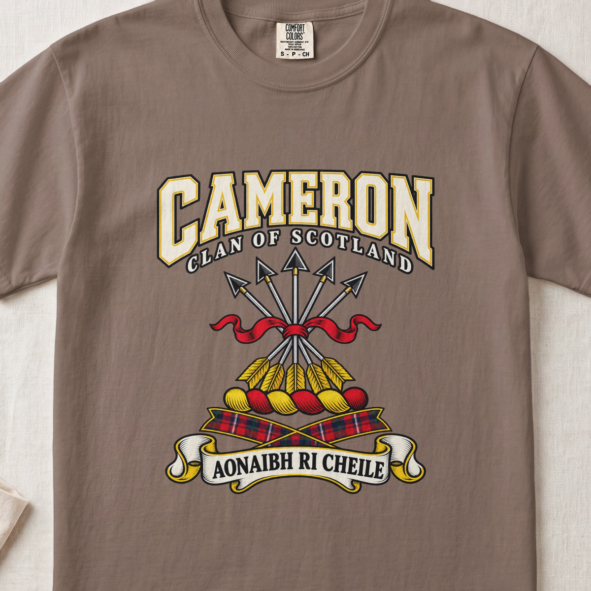 Cameron graphic T-shirt in Espresso brown, front flat lay showing varsity lettering and five arrows tied with red ribbon.