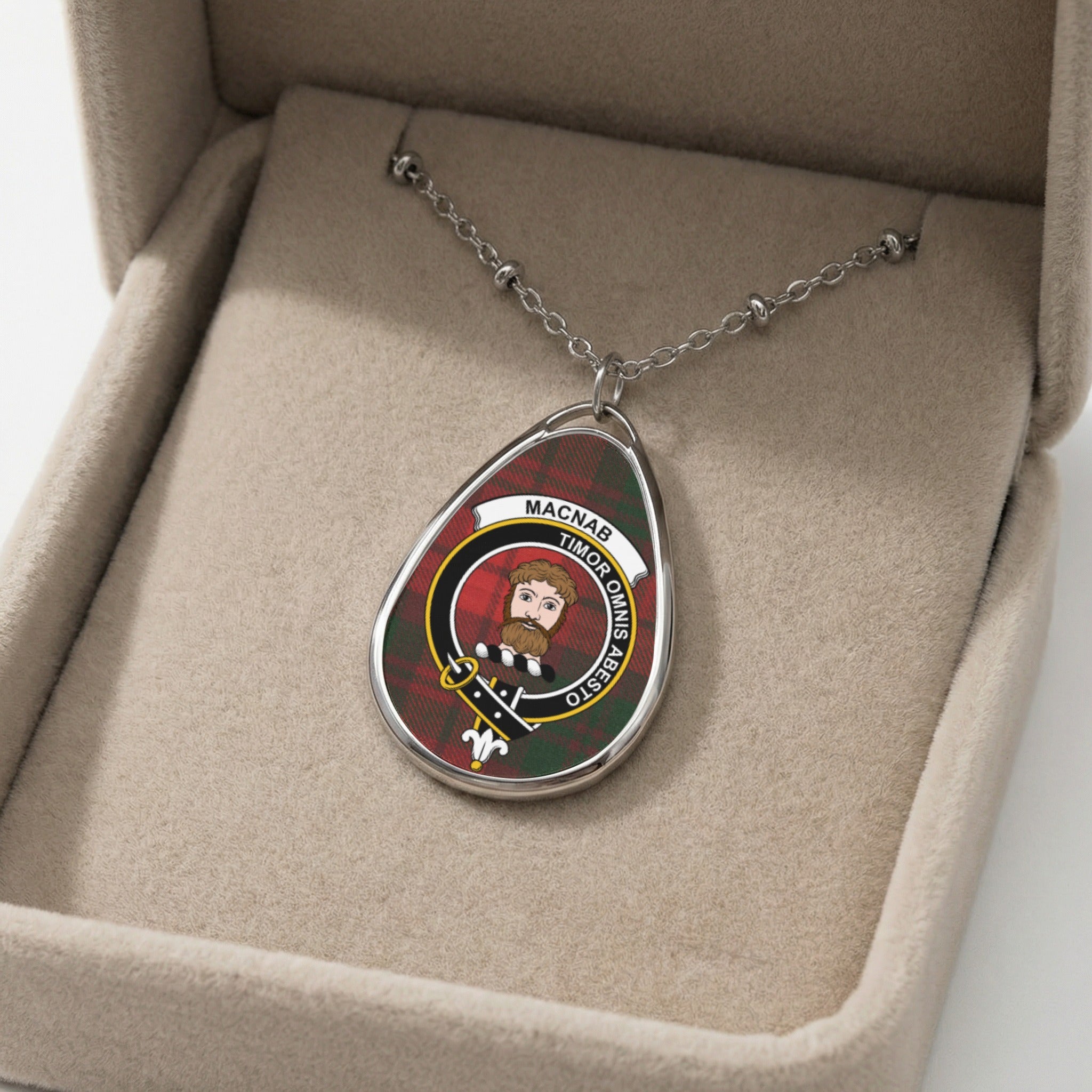 Tartan oval pendant necklace with "Macnab Timor Omnis Abesto" inscription.