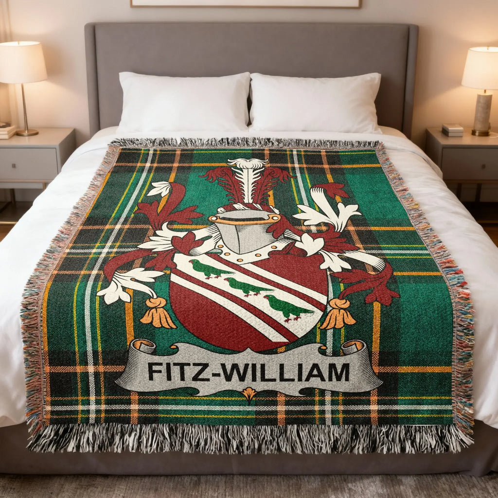 Fitz-William family crest on a green tartan blanket with fringe.