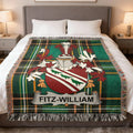 Fitz-William family crest on a green tartan blanket with fringe.
