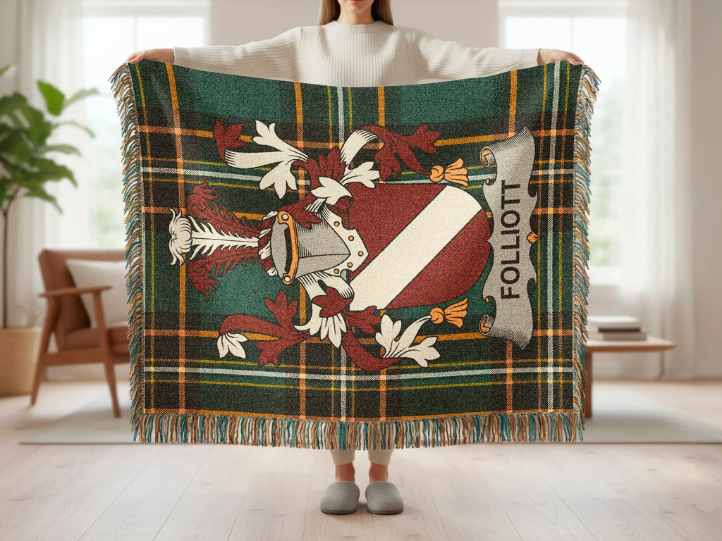 Tartan blanket with family crest reading "Folliott" held by a person.