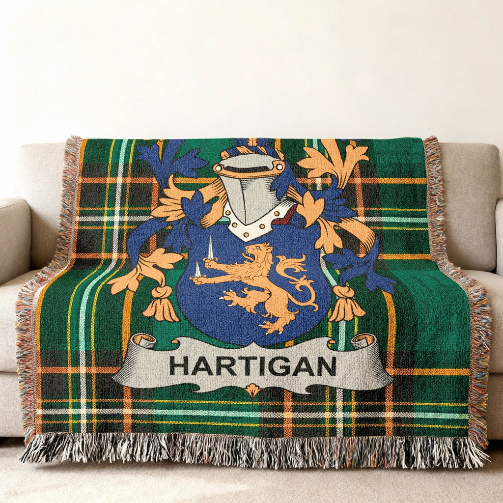 Woven blanket with Hartigan family crest on green tartan.