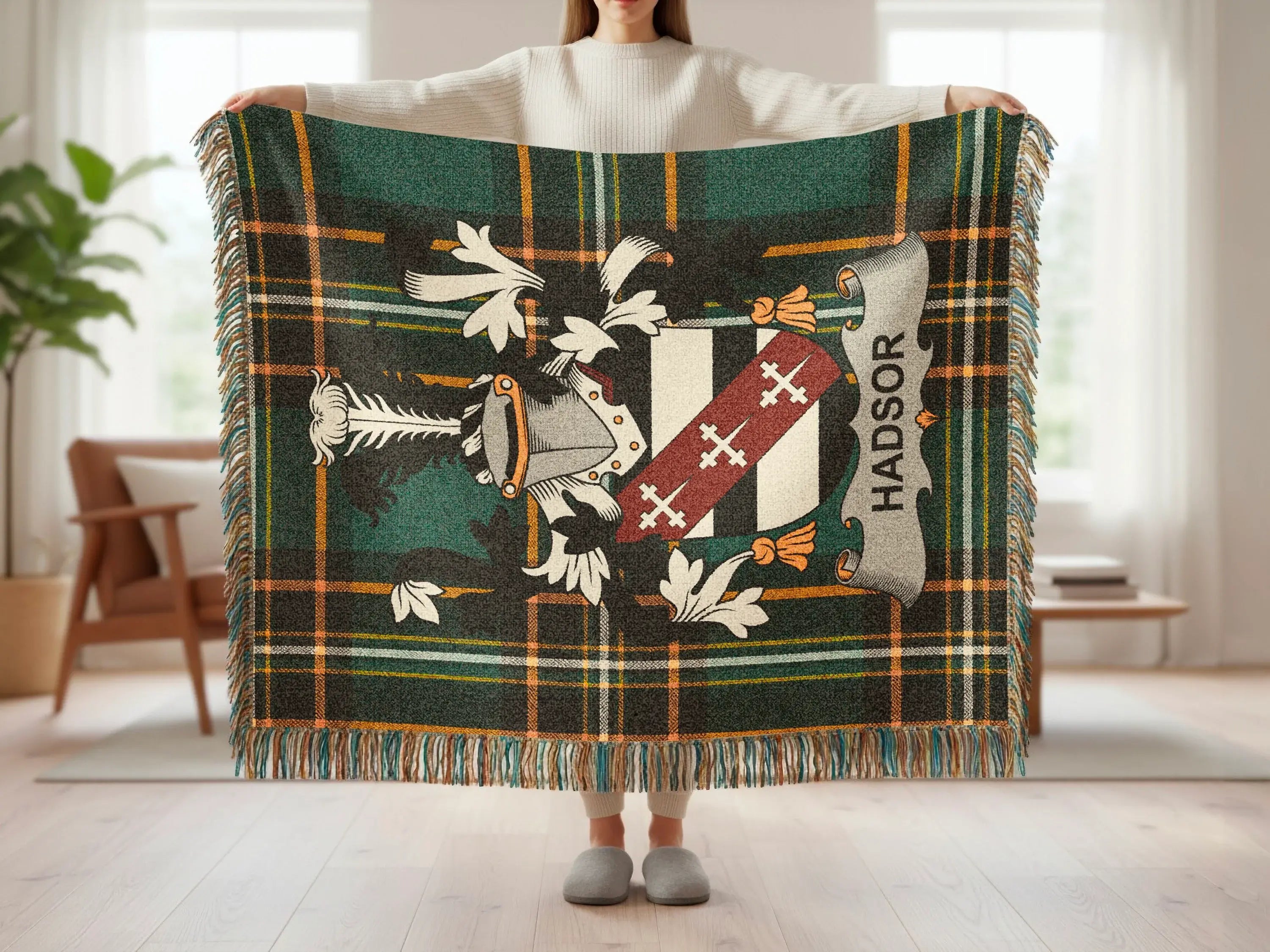 Plaid throw blanket with heraldic crest and "HADSOR" text.