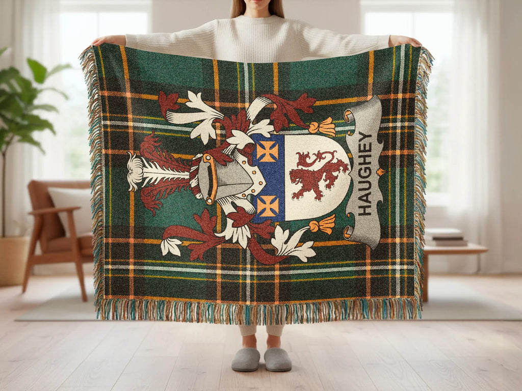 Haughey tartan plaid throw blanket with family crest, held by a person.
