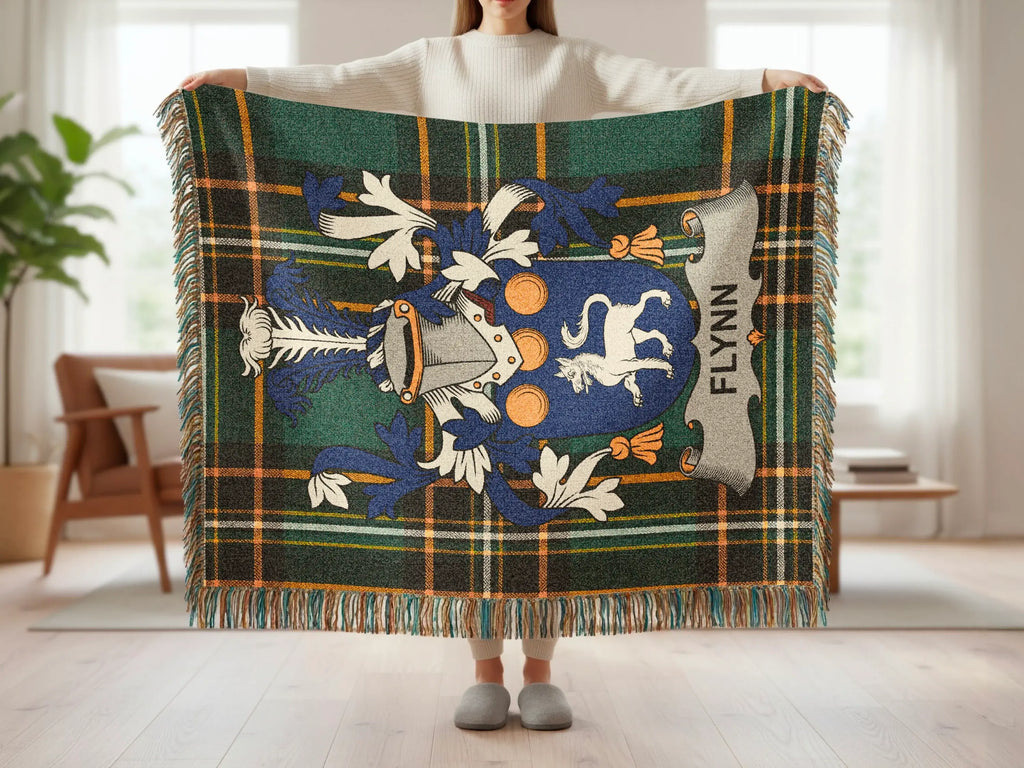 Tartan plaid blanket with Flynn family crest displayed.